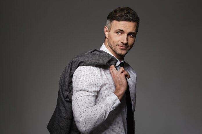 Image of successful businessman wearing costume looking on camer